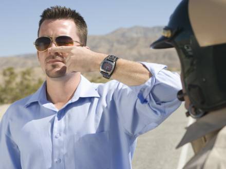 A man in sunglasses with policemen